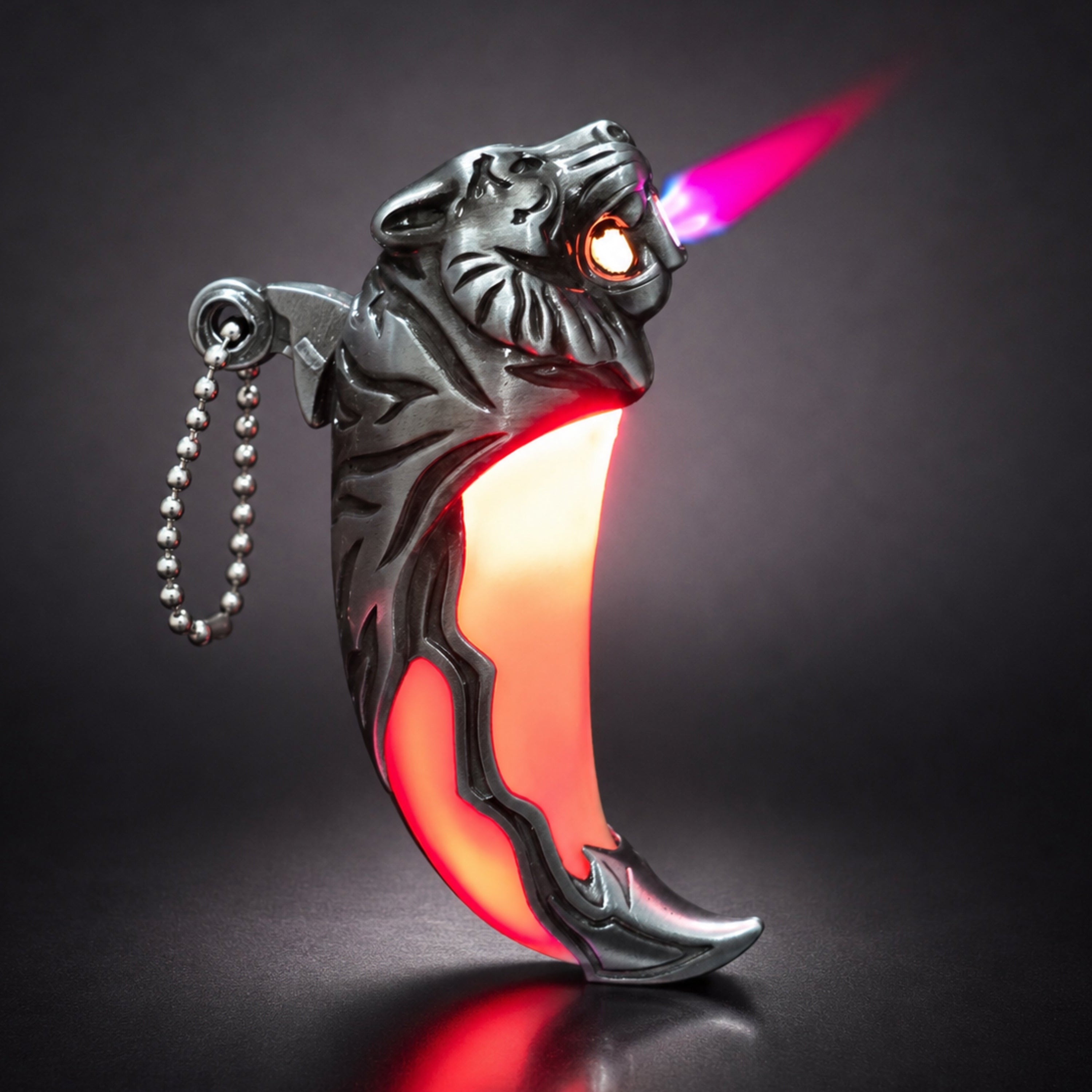 Dragon-shaped lighter with a lit flame on a dark background
